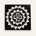 Heart Blossom actual stencil design on white backing, displayed against a cleaned ivory background.
