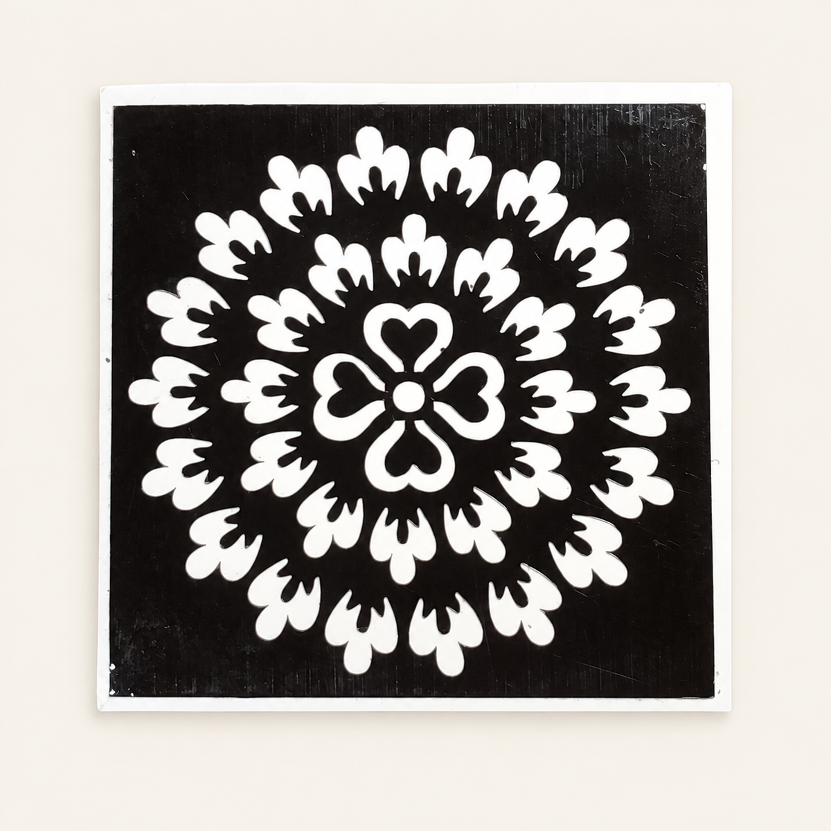 Heart Blossom actual stencil design on white backing, displayed against a cleaned ivory background.